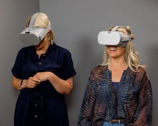 two women wearing virtual reality headsets on your garden made perfect