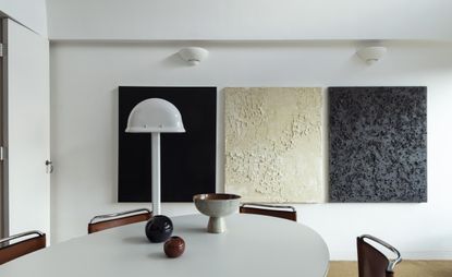 Oskar Kohnen's Barbican apartment with white dining table and black, white and grey art