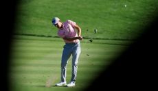Webb Simpson hits an iron shot from the fairway