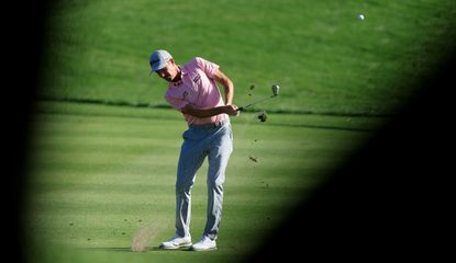 Webb Simpson hits an iron shot from the fairway