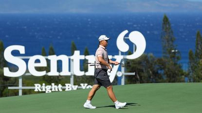 Tom Kim walks along a green on the Plantation Course at Kapalua Resort during the 2024 Sentry