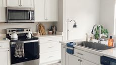 Clean kitchen with lamp and gray features