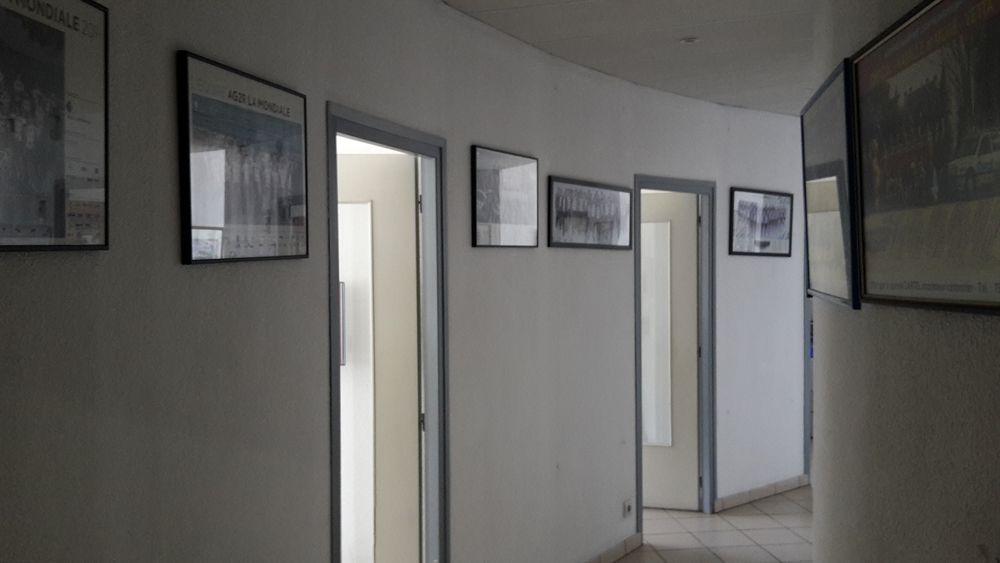 The semi-circular corridors are lined with photos of the team