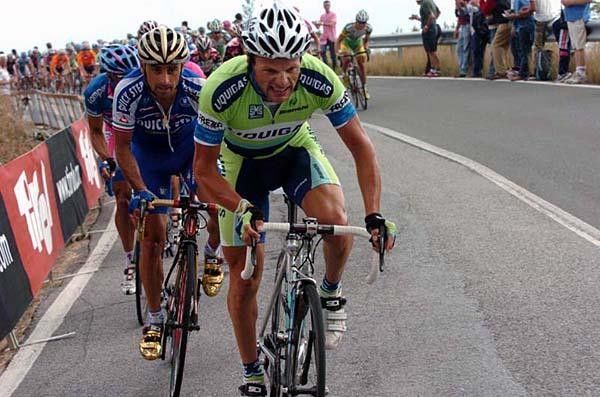Danilo Di Luca grimaces after being involved in an early crash