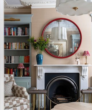 living room with fireplace, mirror and statement light