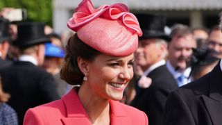 Britain's Catherine, Duchess of Cambridge speaks to guests at a Royal Garden Party at Buckingham Palace in London on May 18, 2022.