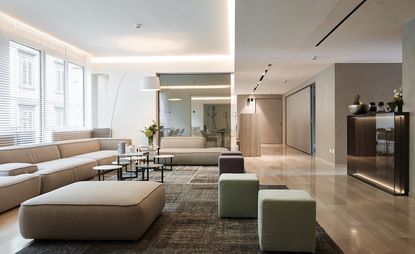 Lounge area featuring neutral tones, sleek wooden floor and simple furnishing