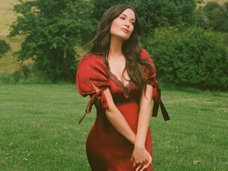 Kacey Musgraves wearing a red dress from the Reformation x Kacey Musgraves collection.