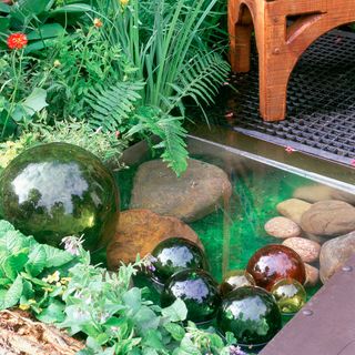 garden waterballs with grass and stone