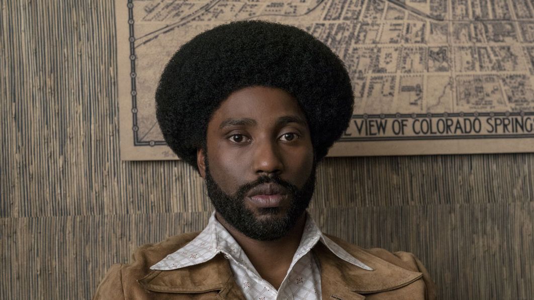 John David Washington looks at the camera pensively in BlacKkKlansman