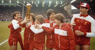 Liverpool captain Graeme Souness (l) celebrates with team mates from left to right, Michael Robinson,John Wark (obscured by trophy) Kenny Dalglish, Alan Hansen, Steve Nicol and Bruce Grobbelaar pictured with the Canon League Division One trophy for the 1983/84 season before their match against Norwich City at Anfield on May 15th, 1984 in Liverpool, England.