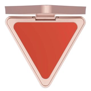 A triangle shaped coral cream blush for Black-owned beauty and skincare brands.
