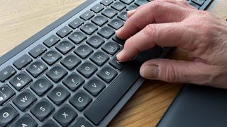 MX Keys S, hand typing close-up