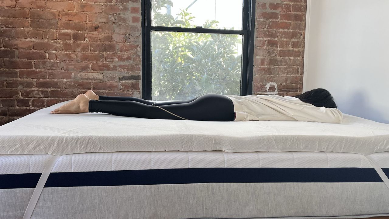 Woman lying on Tempur-Adapt Topper on her front