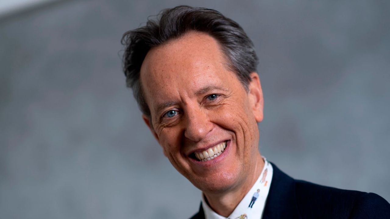 richard e grant on a gray background