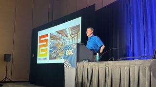 Jesse Schell, CEO at Schell Games, at a podium for his GDC panel, "The Future of MR Experiences". The slide shows the Schell Games logo.
