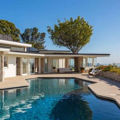 house exterior with pool area and white wall