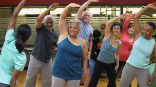 Why is exercise important? Image shows group of people exercising together in a class
