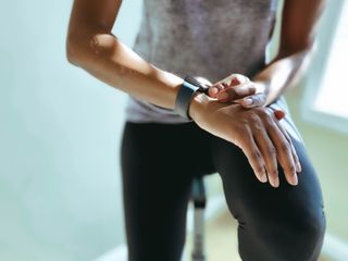 Exercise motivation: A woman checking her fitness tracker