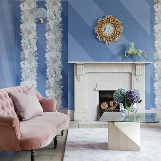 living room with fireplace and printed blue wall
