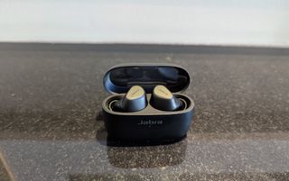 The Jabra Connect 5T wireless earbuds in their charging case