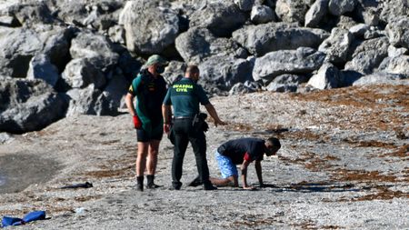 Spanish Civil guards approach a migrant in the Spanish enclave of Ceuta