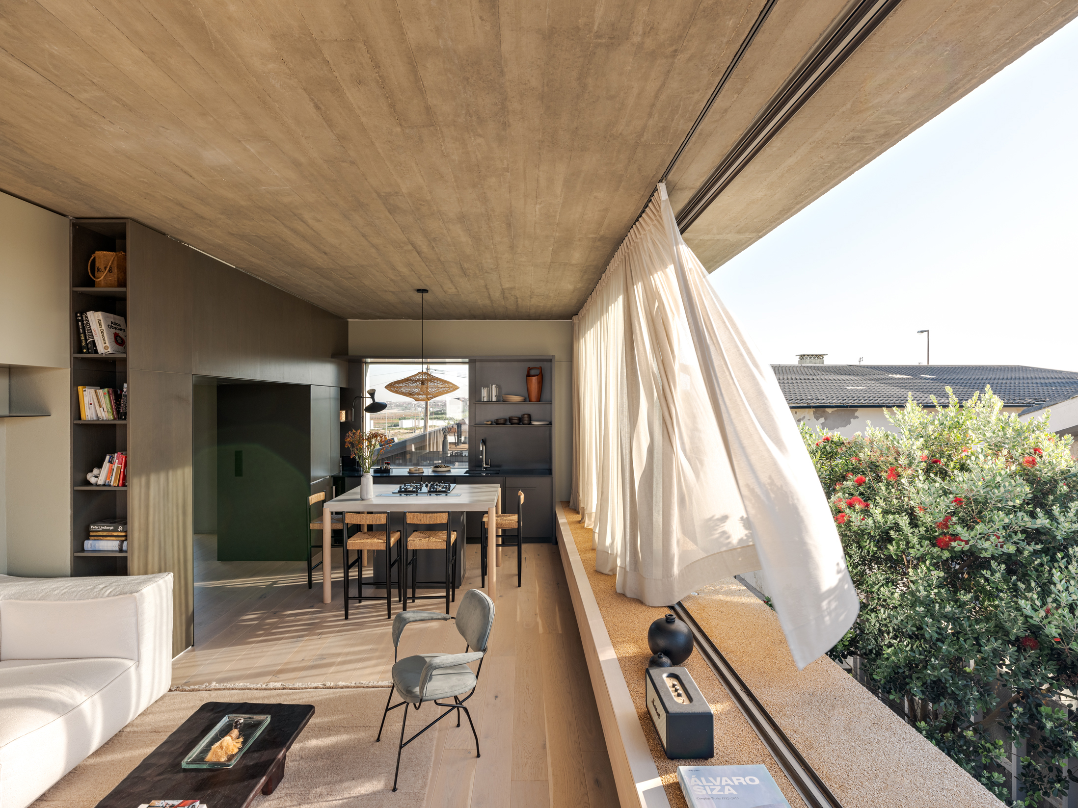 Sliding glazing opens up the upper floor living and dining area