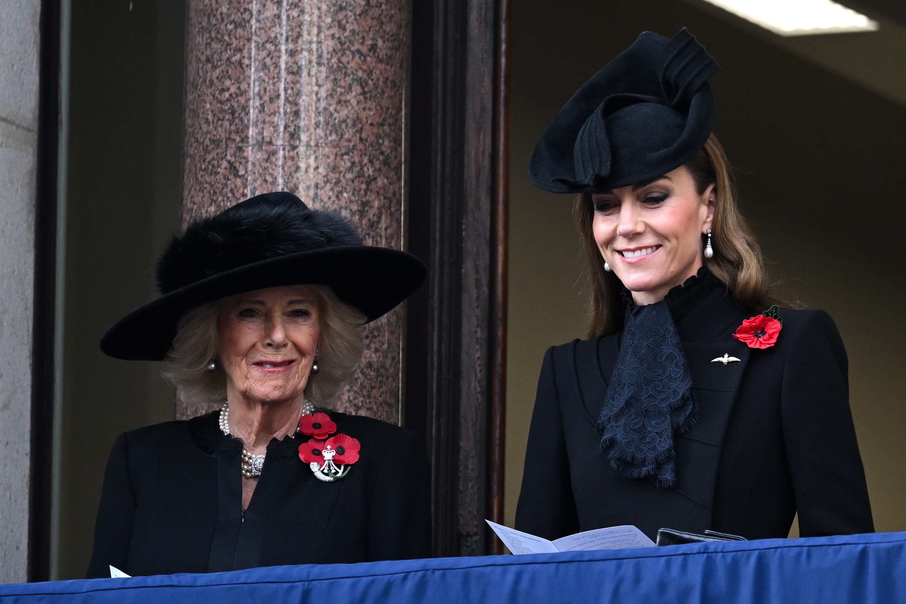 Queen Camilla and Catherine, Princess of Wales Kate Middleton smile during the 2025 National Service Of Remembrance at The Cenotaph on November 09, 2025 in London, England