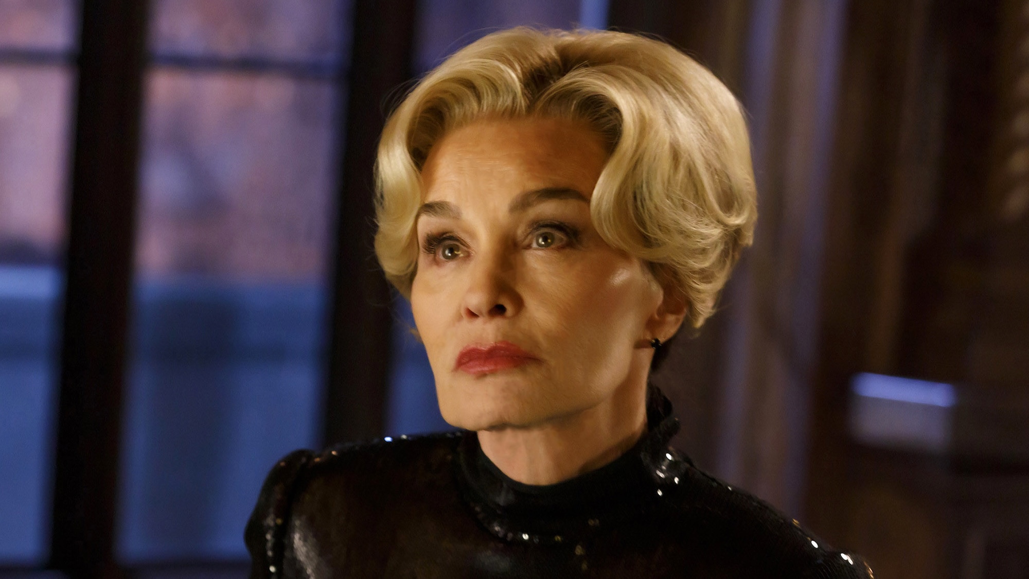 Jessica Lange as Constance Langdon with ear-length blonde hair and wearing a black leather outfit in American Horror Story 13