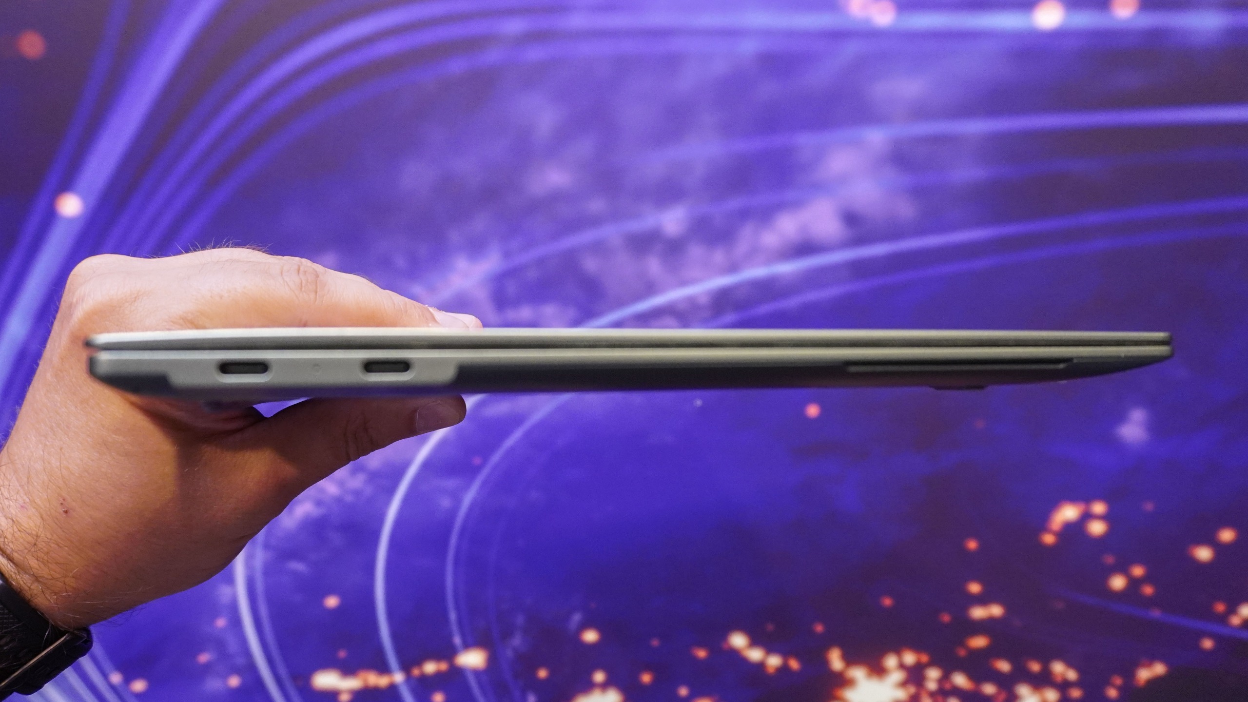 A person holding Lenovo's Project AeroBlade concept laptop in hand with the lid closed