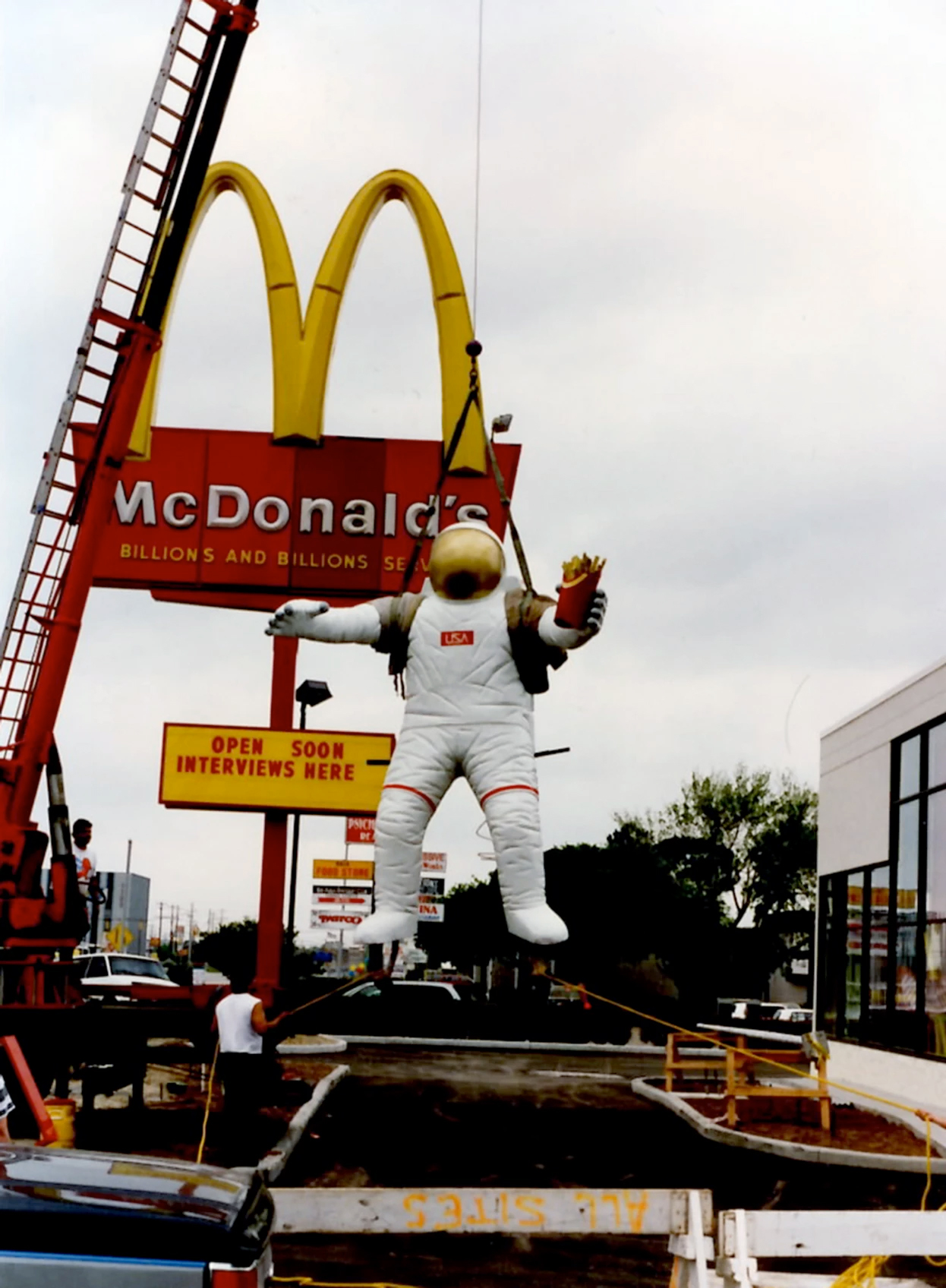 Artist John Knott's original astronaut statue seen being installed in 1995 at the now former McDonald's restaurant on NASA Road 1 in Houston, Texas, near Space Center Houston and NASA's Johnson Space Center.