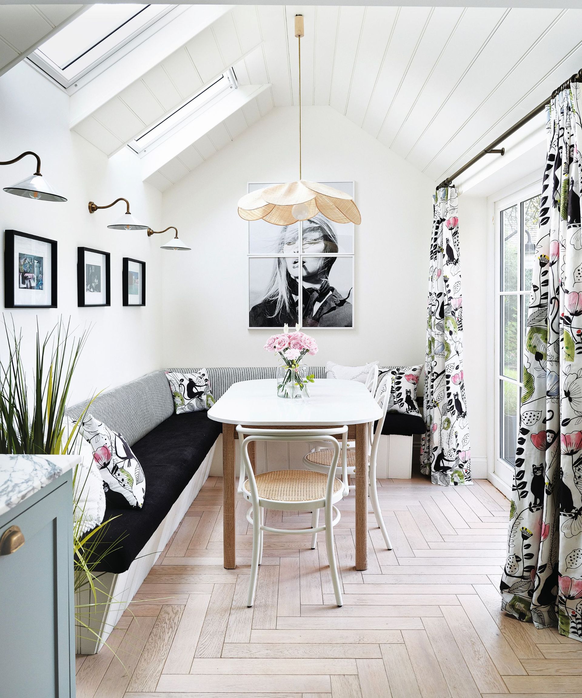 White bench with cushions, white dining table and chairs