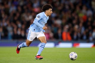 Rico Lewis of Manchester City runs with the ball during the UEFA Champions League Group G match between Manchester City and FK Crvena zvezda at Etihad Stadium on September 19, 2023 in Manchester, England.