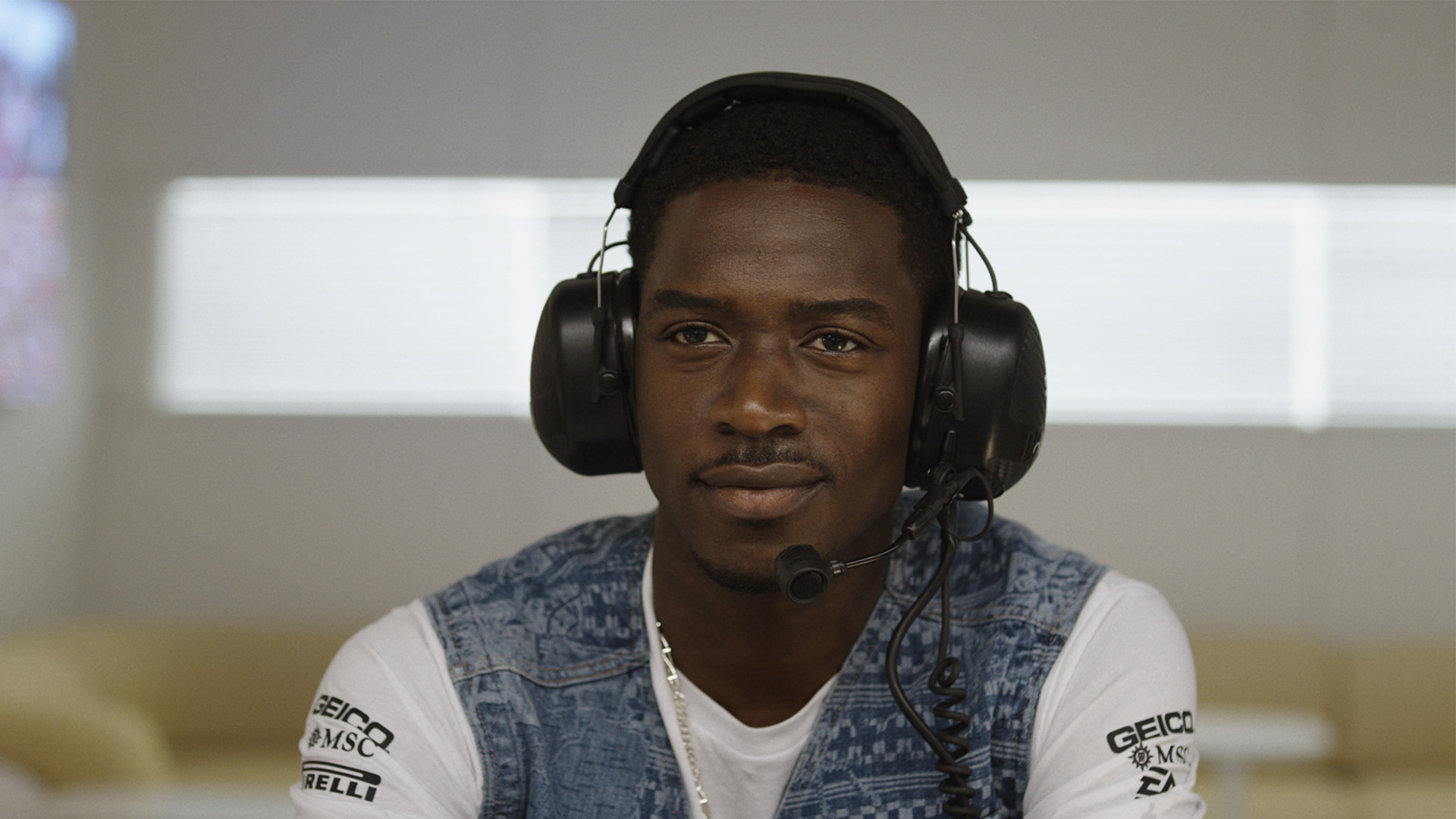 Damson Idris wearing earmuffs in the F1 movie 