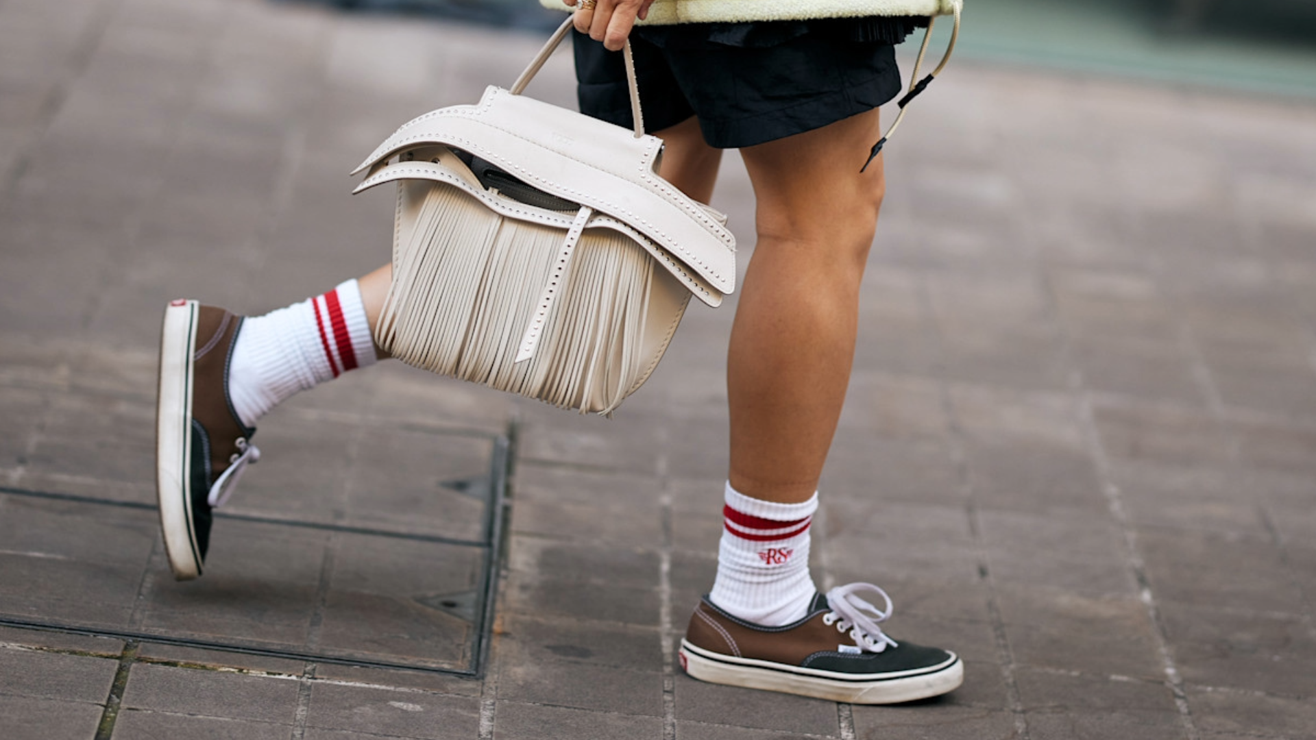 woman wearing brown vans sneakers and shorts in London