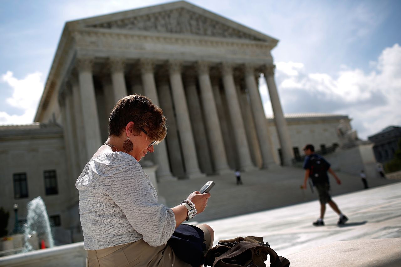 Woman on phone outside of Supreme Court building