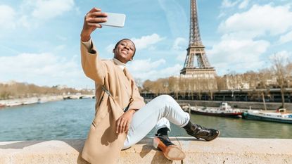 A woman takes a selfie in Paris.