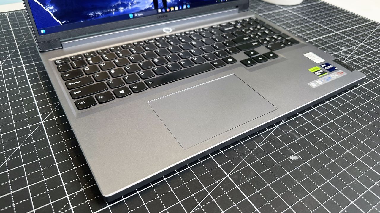 The keyboard deck on the Lenovo Legion 5i Gen 9 seen from above on a gray desk mat