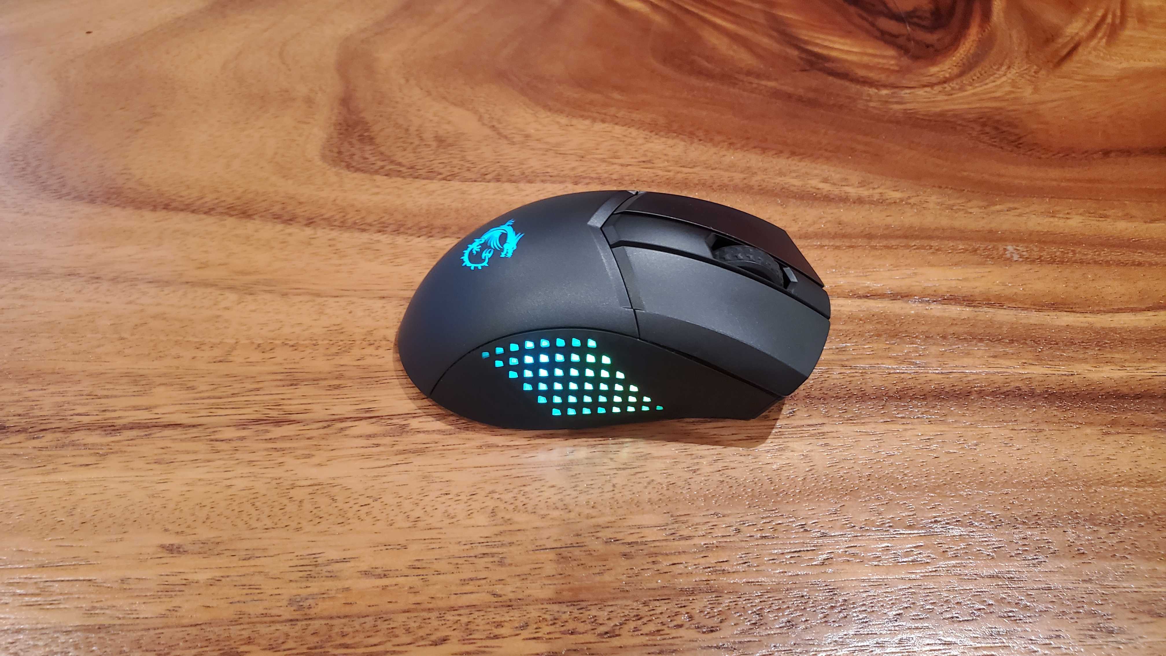 black gaming mouse on a wooden table