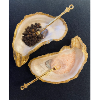 Oyster salt and pepper set with golden spoons.