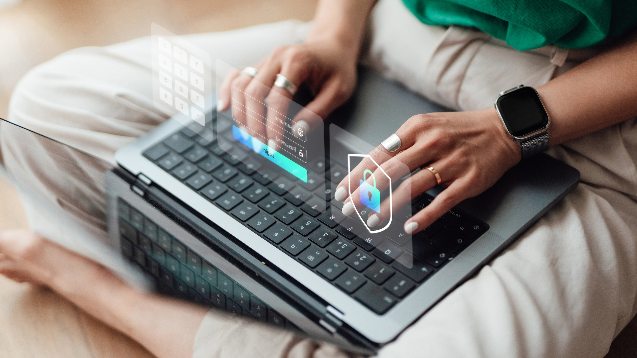 Person with laptop in their lap, typing on keyboard
