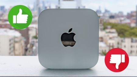 A Mac mini M6 on its side with a thumbs up and a thumbs down on either side
