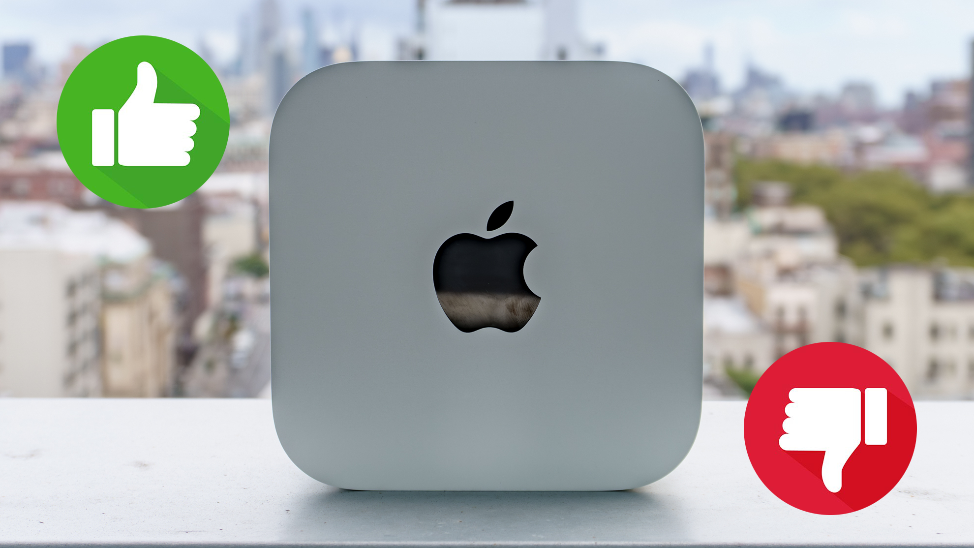 A Mac mini M6 on its side with a thumbs up and a thumbs down on either side