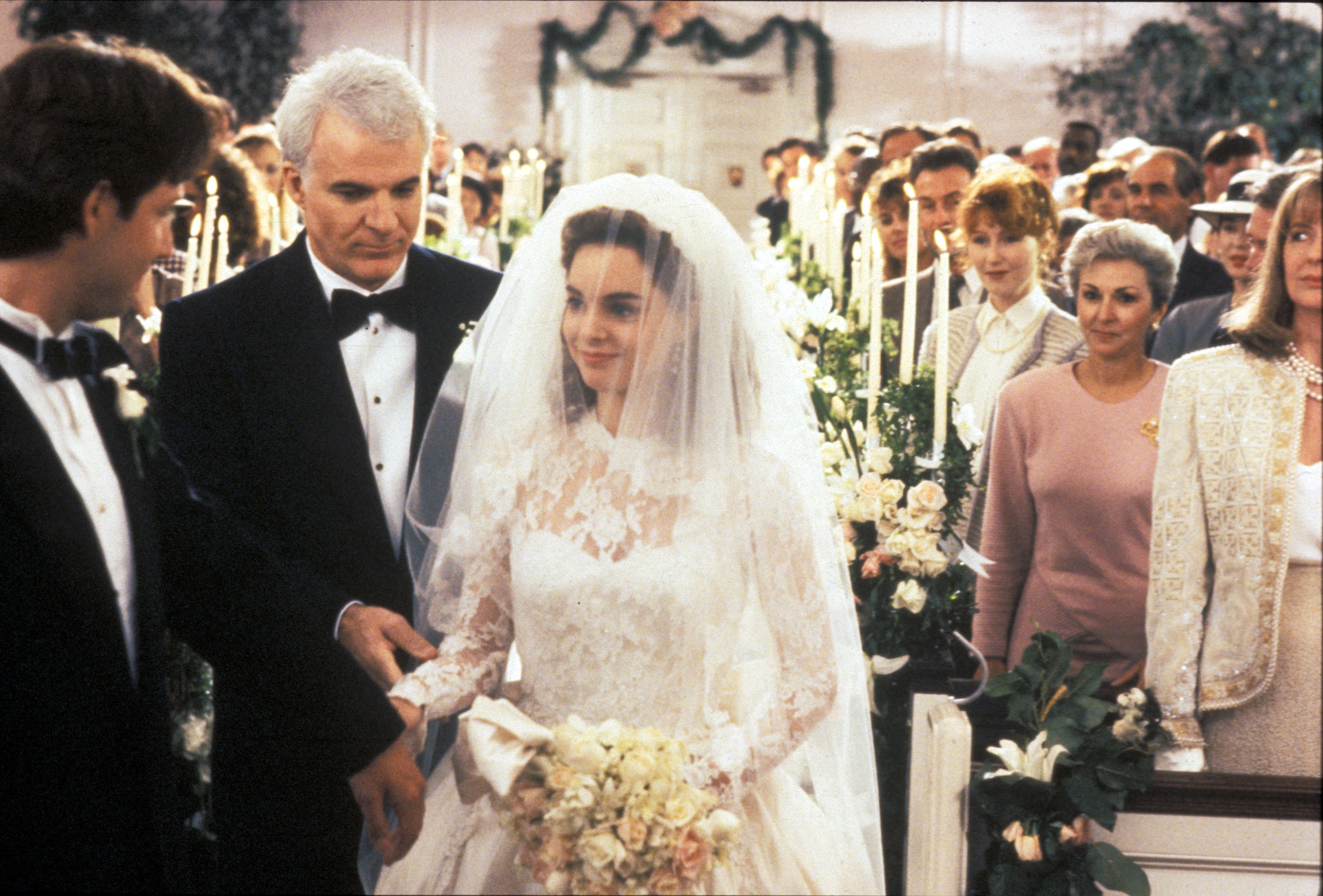 Steve Martin in a tux walking a daughter in a wedding gown down the aisle in 'Father of the Bride'