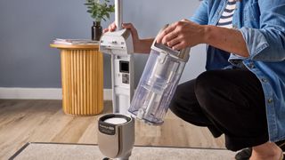 Tester removing the bin from the Shark Freestyle Pro cordless upright vacuum