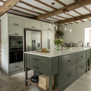 Green open plan kitchen with island