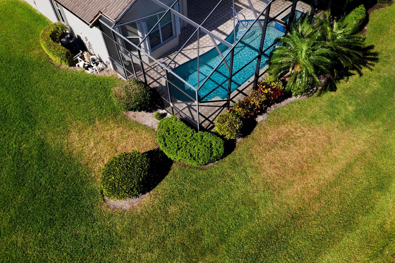 Patches in grass with a house and swimming pool