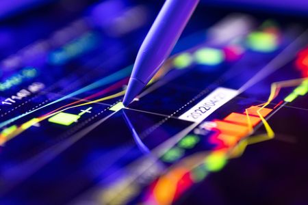 closeup of stock market chart with pen on moving average