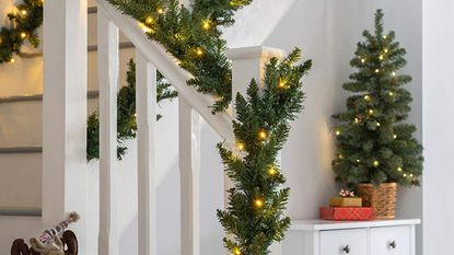 pre lit Christmas decoration deal on garland round staircase