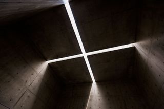 cross with light shining through at Museum SAN